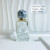 Low Moq Clear Square Round Shape Spray Glass Perfume Bottle 50ml Volcano Base Perfume Glass Bottles with Resin Ball Cap